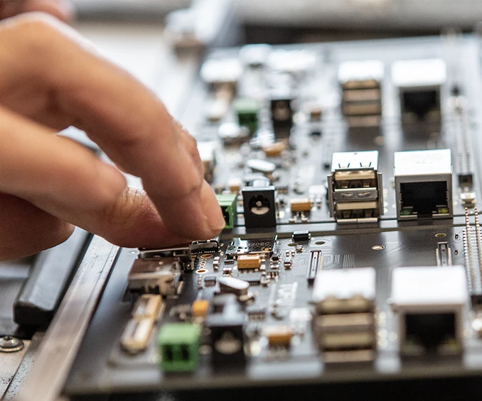 THT assembly on an electronic board that has already been pre-assembled with SMD components, demonstrating the combination of surface mount and through-hole assembly techniques in electronic board assembly.
