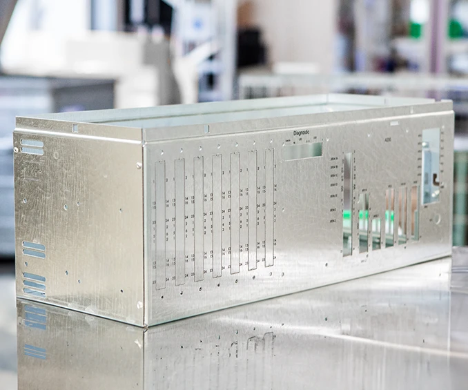 Photo of a custom-designed sheet metal housing by CLOOS electronic , created for the integration of industrial electronics. The housing features precise screen printing that represents the brand and technical information. The design exemplifies the high-quality craftsmanship and adaptability to specific customer requirements in the field of industrial electronic applications.